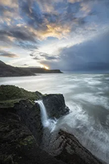Coastal waterfall at sunrise, Isle of Purbeck, Jurassic Coast World Heritage Site, Dorset Coastal waterfall at sunrise, Isle of Purbeck, Jurassic Coast World Heritage Site, Dorset