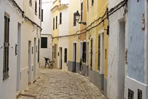 Colourful buildings line a narrow street in the old town of Ciutadella, Ciudadela Colourful buildings line a narrow street in the old town of Ciutadella, Ciudadela