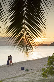 Couple on Matira Beach at sunset, Bora Bora, Society Islands, French Polynesia Couple on Matira Beach at sunset, Bora Bora, Society Islands, French Polynesia