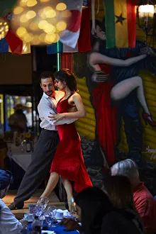 A couple of tango dancers perform a live-show in a restaurant of La Boca, Buenos Aires A couple of tango dancers perform a live-show in a restaurant of La Boca, Buenos Aires