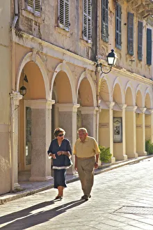 Couple Walking Through Corfu Old Town, Corfu, The Ionian Islands, Greek Islands, Greece Couple Walking Through Corfu Old Town, Corfu, The Ionian Islands, Greek Islands, Greece