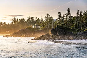 Cox Bay beach and surfers at sunset, Tofino, British Columbia, Vancouver Island, Canada Cox Bay beach and surfers at sunset, Tofino, British Columbia, Vancouver Island, Canada