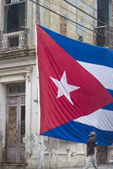 Cuba, Huge Cuban flag hanging across buildings in a street in Santa Clara, after Cuba, Huge Cuban flag hanging across buildings in a street in Santa Clara, after