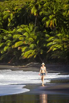 Dominica, Hampstead. A woman walks along No 1 Beach. (MR) Dominica, Hampstead. A woman walks along No 1 Beach. (MR)
