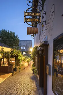 Drosselgasse Street at dusk, Rudesheim, Rhineland-Palatinate, Germany Drosselgasse Street at dusk, Rudesheim, Rhineland-Palatinate, Germany
