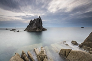Dusk on modeled cliffs by wind framing blue sea Capo Testa Santa Teresa di Gallura Dusk on modeled cliffs by wind framing blue sea Capo Testa Santa Teresa di Gallura