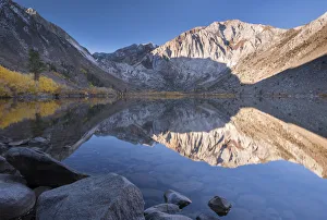 Early morning sunshine lights the Eastern Sierra Mountains beyond Convict Lake, California Early morning sunshine lights the Eastern Sierra Mountains beyond Convict Lake, California