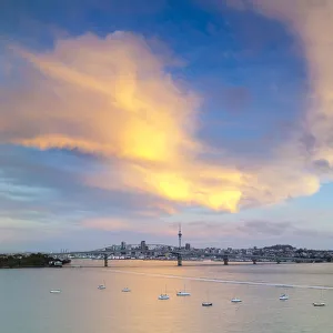 Elevated View Towards the Harbour Bridge and Central Business District illuminated at sunset, Auckland Elevated View Towards the Harbour Bridge and Central Business District illuminated at sunset, Auckland