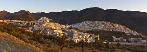 Elevated view over the historic hilltop town of Moulay Idriss illuminated at sunset Elevated view over the historic hilltop town of Moulay Idriss illuminated at sunset