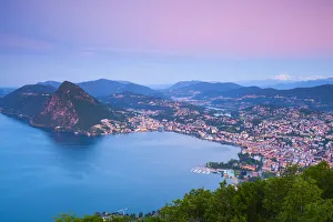 Elevated view over Lugano from Monte Bre illuminated at sunrise, Lugano, Lake Lugano Elevated view over Lugano from Monte Bre illuminated at sunrise, Lugano, Lake Lugano