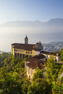 Elevated view over the picturesque Sanctuary of Madonna del Sasso illuminated at sunrise Elevated view over the picturesque Sanctuary of Madonna del Sasso illuminated at sunrise
