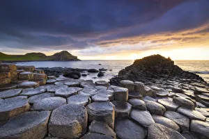 An epic sunset at the Giants Causeway with its iconic basalt columns An epic sunset at the Giants Causeway with its iconic basalt columns