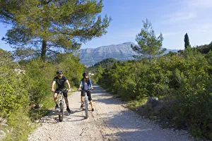 Europe, Balkans, Croatia, Korcula, cyclists mountain biking around Korcula island (MR) Europe, Balkans, Croatia, Korcula, cyclists mountain biking around Korcula island (MR)