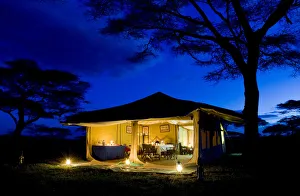 Evening image of dining tent, safari camp, Tanzania Evening image of dining tent, safari camp, Tanzania