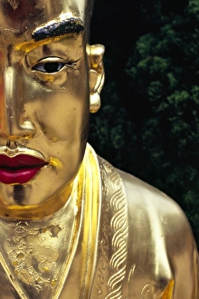 Face of a golden Buddha statue - one among many at Face of a golden Buddha statue - one among many at