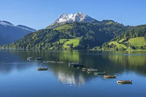 Fisher boats on Lake Wagital with Fluebrig mountain in the Glarner Alps at fall, Innerthal Fisher boats on Lake Wagital with Fluebrig mountain in the Glarner Alps at fall, Innerthal