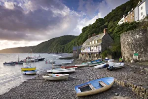 Fishing boats on the pebble beach in Clovelly harbour at dawn, Devon, England. Autumn Fishing boats on the pebble beach in Clovelly harbour at dawn, Devon, England. Autumn