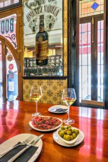 Glasses of white wine with olives and cecina dried meat served in a tapas bar of Valencia, Spain Glasses of white wine with olives and cecina dried meat served in a tapas bar of Valencia, Spain