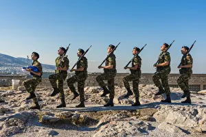 Greek army soldiers perform a ceremonial march on the Acropolis before raising the Greek army soldiers perform a ceremonial march on the Acropolis before raising the