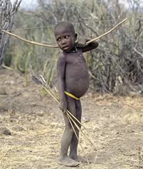 Lake Eyasi Collection: A Hadza boy carrying a bow and arrows