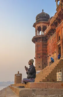 Hinduist practicising meditation, Cityscape from Ganges, Varanasi, Uttar Pradesh, India Hinduist practicising meditation, Cityscape from Ganges, Varanasi, Uttar Pradesh, India