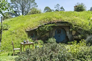 Hobbit house with table and chair in the garden Hobbit house with table and chair in the garden