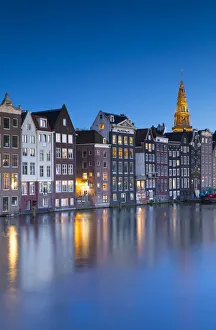 Houses along Damrak at dusk, Amsterdam, Netherlands Houses along Damrak at dusk, Amsterdam, Netherlands