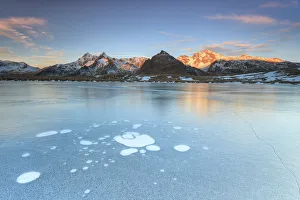Ice bubbles on the frozen surface of Andossi Lake at sunrise Spluga Valley Valtellina Ice bubbles on the frozen surface of Andossi Lake at sunrise Spluga Valley Valtellina
