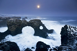 Iceland, characteristic cliff overlooking the sea, illuminated by the moonlight Iceland, characteristic cliff overlooking the sea, illuminated by the moonlight