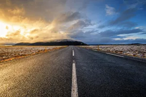 Iceland, Northern Europe. A paved road with dramatic sky Iceland, Northern Europe. A paved road with dramatic sky