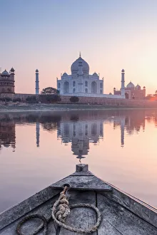 India, view of the Taj Mahal reflecting in the Yamuna river at sunset from a wooden boat India, view of the Taj Mahal reflecting in the Yamuna river at sunset from a wooden boat