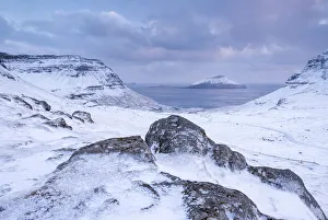 The island of Koltur from the snow covered mountains of Streymoy, Faroe Islands, Denmark The island of Koltur from the snow covered mountains of Streymoy, Faroe Islands, Denmark