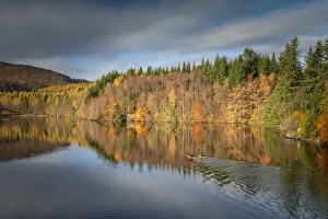 Kayakers on Loch Faskally in Autumn, Perthshire, Scotland Kayakers on Loch Faskally in Autumn, Perthshire, Scotland