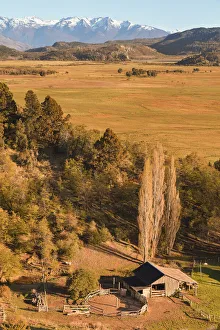The laguna Terraplen valley at sunrise with the Andes mountains snowy peaks in background, Trevelin, Chubut, Patagonia The laguna Terraplen valley at sunrise with the Andes mountains snowy peaks in background, Trevelin, Chubut, Patagonia