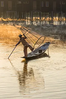 Leg-rowing fisherman of Inle Lake in the morning mist, Shan State, Myanmar Leg-rowing fisherman of Inle Lake in the morning mist, Shan State, Myanmar