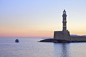 The Lighthouse and Fishing Boat in The Venetian Harbour at Sunrise, Chania, Crete The Lighthouse and Fishing Boat in The Venetian Harbour at Sunrise, Chania, Crete