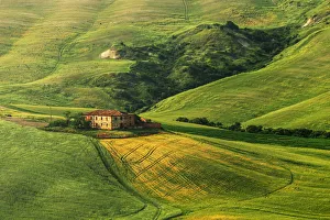 A lonely countryhouse in the heart of the Siena countryside during a spring afternoon A lonely countryhouse in the heart of the Siena countryside during a spring afternoon