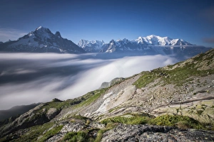 Low clouds and mist frame the snowy peaks of Mont Blanc and Aiguille Verte Chamonix Low clouds and mist frame the snowy peaks of Mont Blanc and Aiguille Verte Chamonix