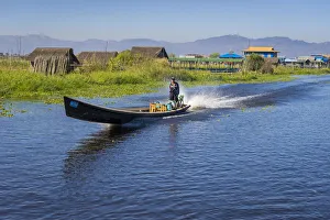 Man going on Inle Lake by boat, Lake Inle, Nyaungshwe Township, Taunggyi District Man going on Inle Lake by boat, Lake Inle, Nyaungshwe Township, Taunggyi District