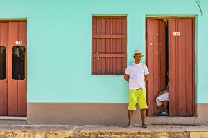 A man standing outside his house in a street in Trinidad, Sancti Spiritus, Cuba A man standing outside his house in a street in Trinidad, Sancti Spiritus, Cuba