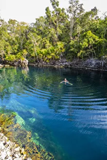 A man swimming in a natural water swiming pool in Playa Giron, Bay of Pigs A man swimming in a natural water swiming pool in Playa Giron, Bay of Pigs