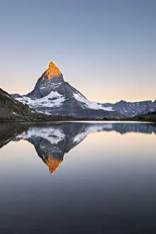 Matterhorn reflected in Riffelsee Lake at dawn (Zermatt, Canton of Valais, Visp Matterhorn reflected in Riffelsee Lake at dawn (Zermatt, Canton of Valais, Visp