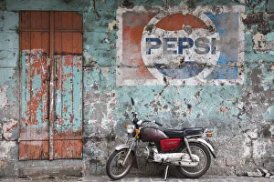 Mauritius, Port Louis, Chinatown, motorbike in front of Pepsi sign Mauritius, Port Louis, Chinatown, motorbike in front of Pepsi sign