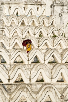 Mingun, Sagaing region, Myanmar (Burma). Woman with red umbrella in the middle of Mingun, Sagaing region, Myanmar (Burma). Woman with red umbrella in the middle of