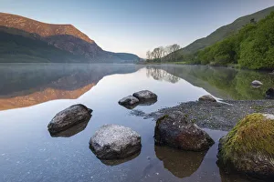 Mirror reflections at dawn on Llyn Cwellyn in Snowdonia National Park, Wales, UK. Spring Mirror reflections at dawn on Llyn Cwellyn in Snowdonia National Park, Wales, UK. Spring