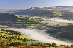 Mist covered rolling countryside backed by the Black Mountains, Brecon Beacons National Park Mist covered rolling countryside backed by the Black Mountains, Brecon Beacons National Park