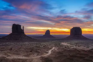 The Mittens against cloudy sky at sunrise, Monument Valley, Arizona, USA The Mittens against cloudy sky at sunrise, Monument Valley, Arizona, USA