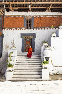 A monk walking in Trongsa Dzong, Trongsa District, Bhutan A monk walking in Trongsa Dzong, Trongsa District, Bhutan