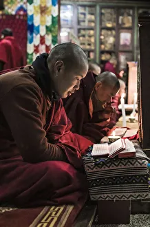 Monks during evening candle light prayer in Lhodrak Kharchu monastery, Jakar Monks during evening candle light prayer in Lhodrak Kharchu monastery, Jakar
