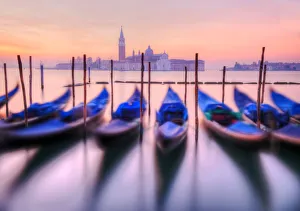 Moored gondolas with San Giorgio Maggiore in the background at dawn, Venice, Veneto Moored gondolas with San Giorgio Maggiore in the background at dawn, Venice, Veneto